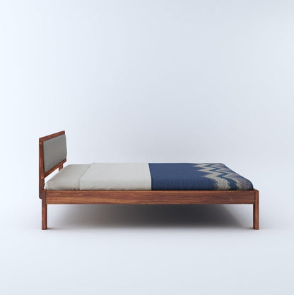 Side view of bed with cushion headboard

