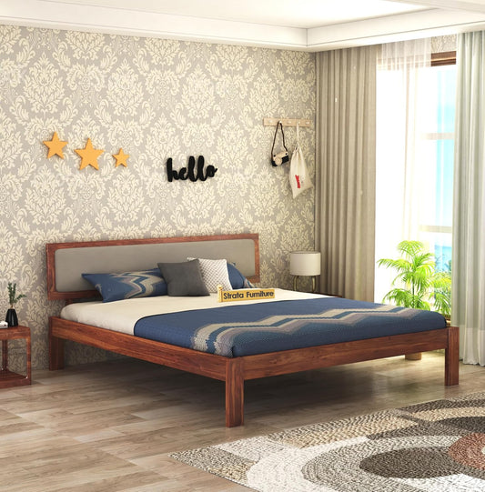 Wooden bed with mattress and grey cushion

