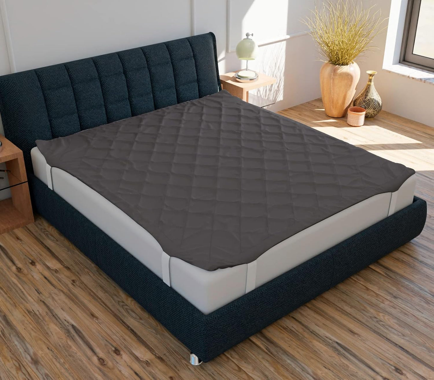 A navy blue mattress protector on a queen-sized bed with a textured surface, displayed in a room setting with decorative elements around.